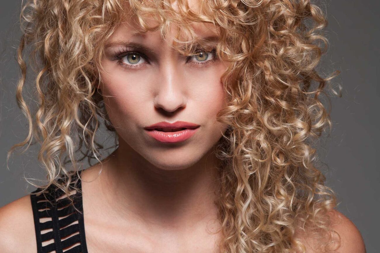 beauty head shot of woman with curly blonde hair