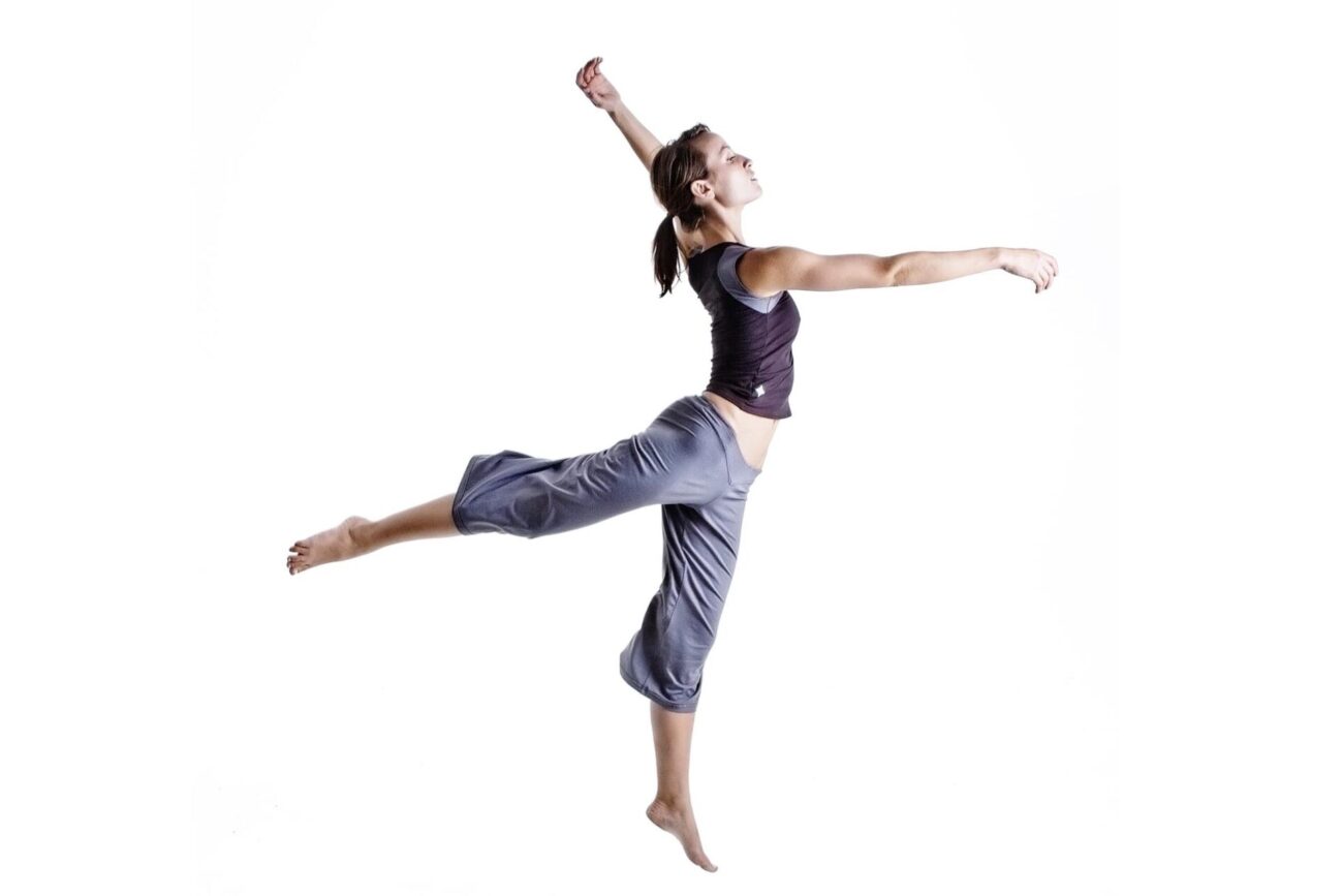 Jumping woman in yoga pants